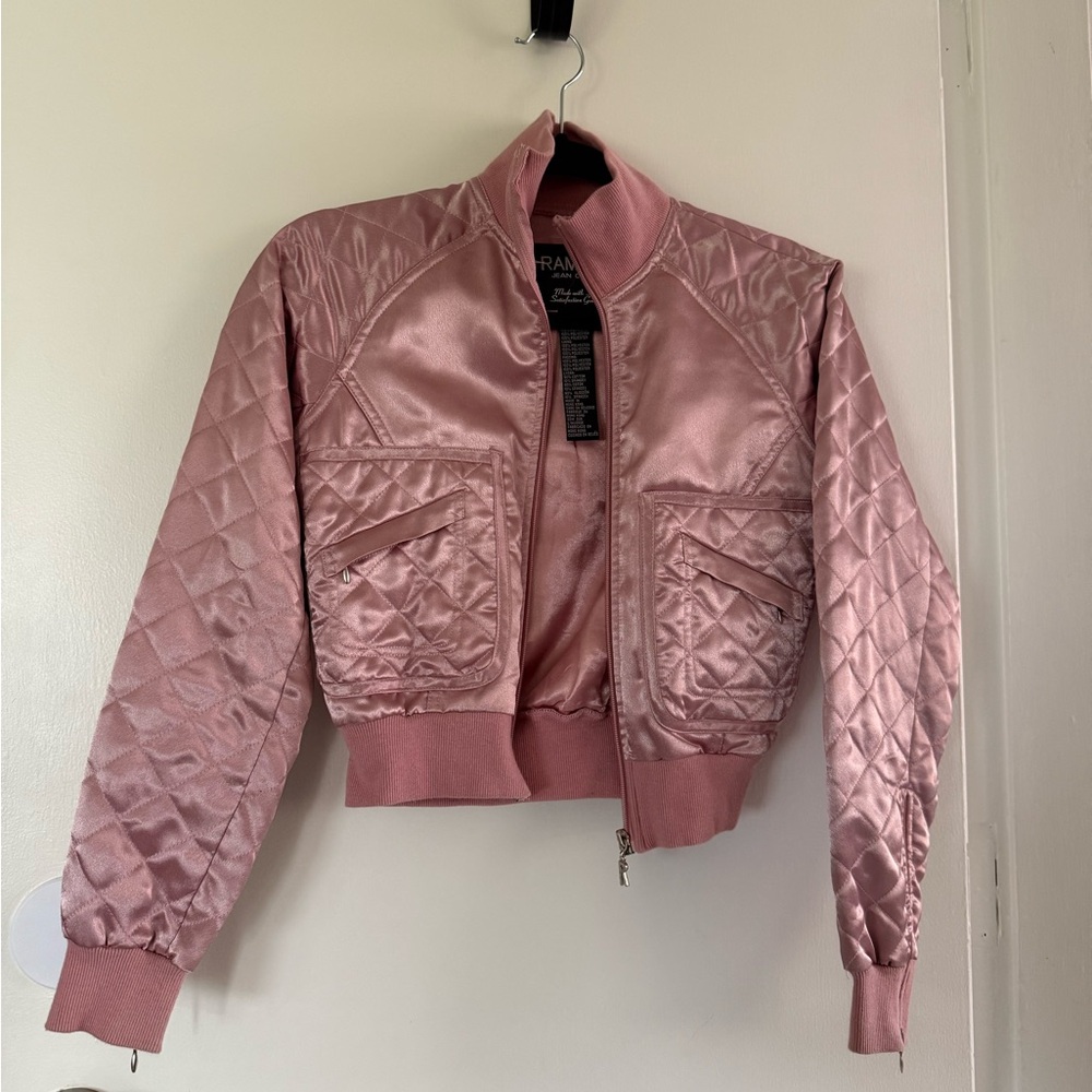 Small polyester pink jacket with zipper and zipper on the arms.